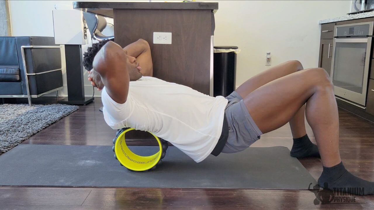 Nurudeen performs a spinal erectors self-massage exercise